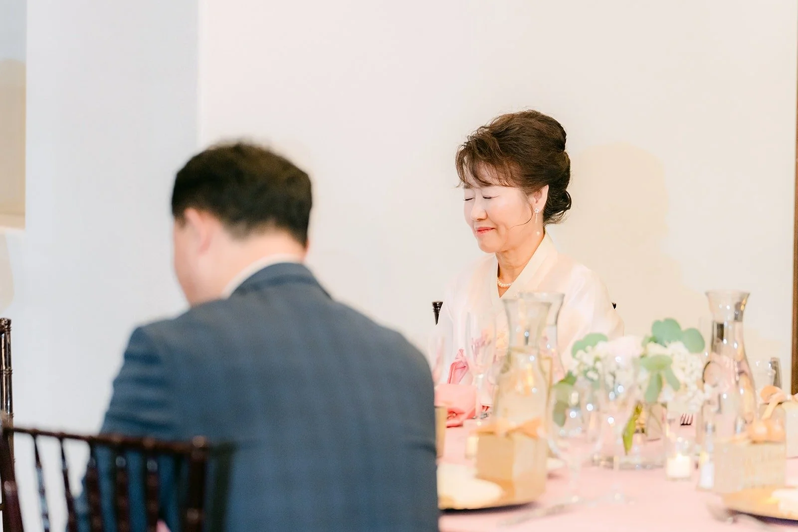 Ivy and Chungman listening to speeches from their table