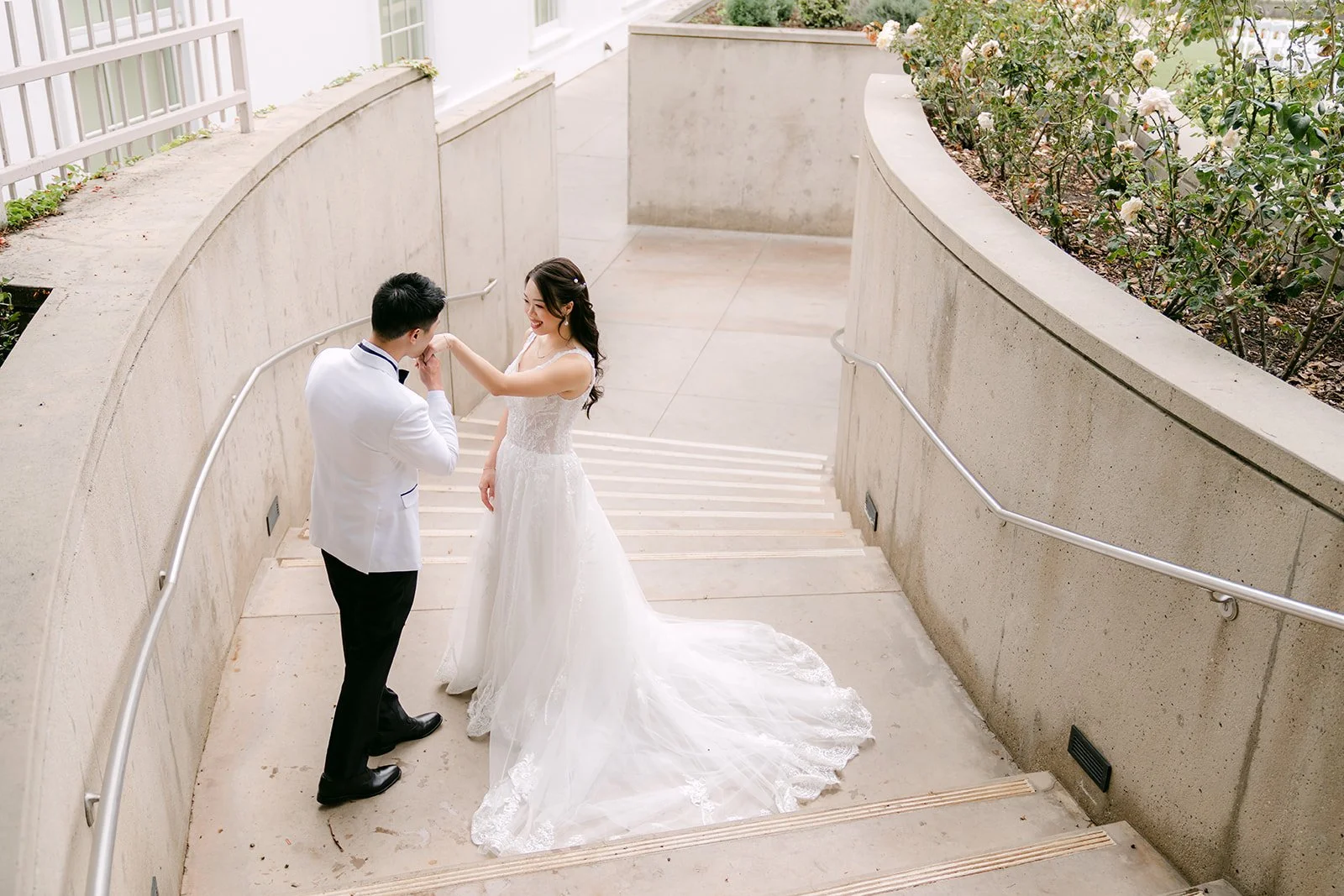 Jenny and Ryan on the curving walkway between white walls.