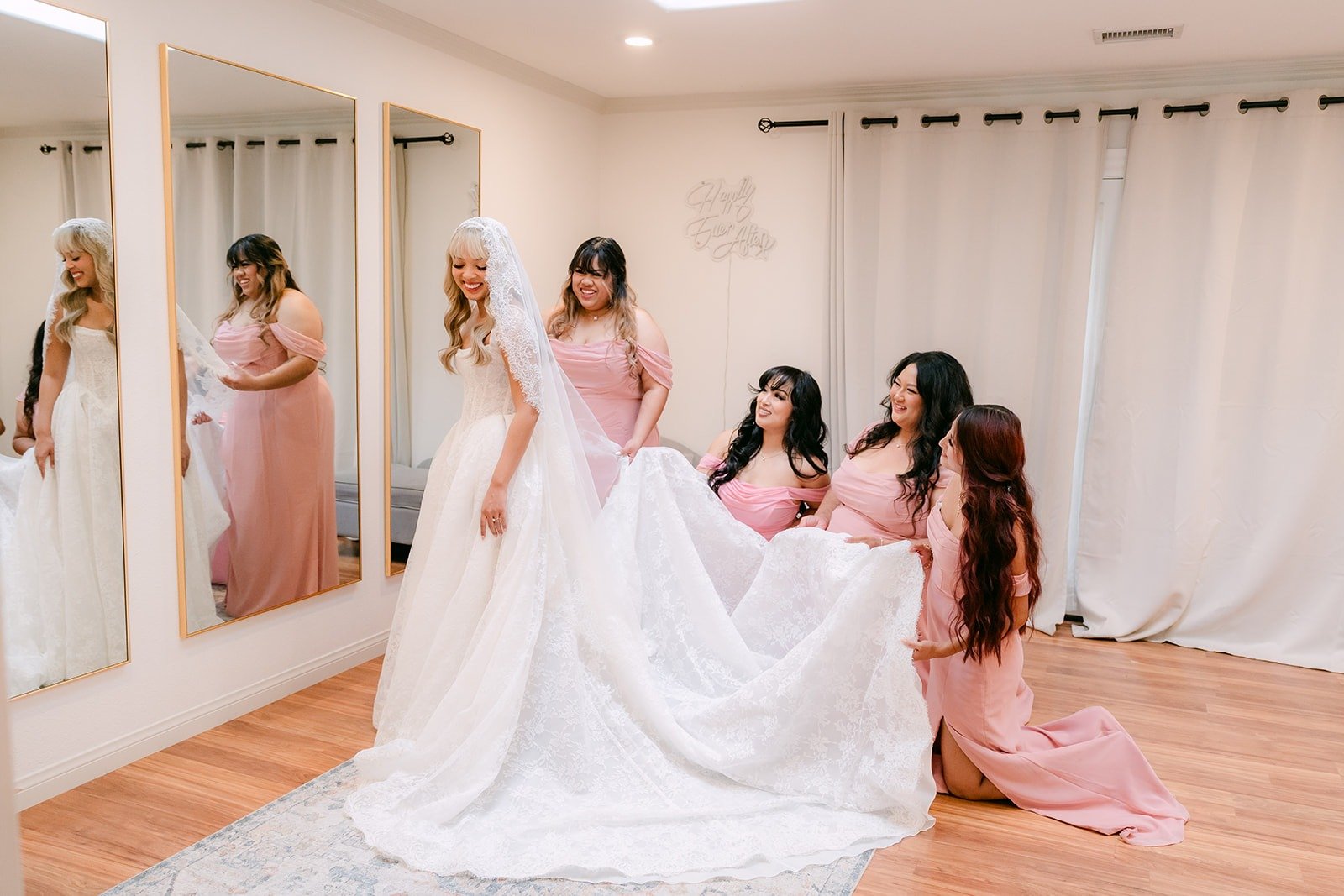 Bridesmaids fluffing Konitha's gown in the bridal suite