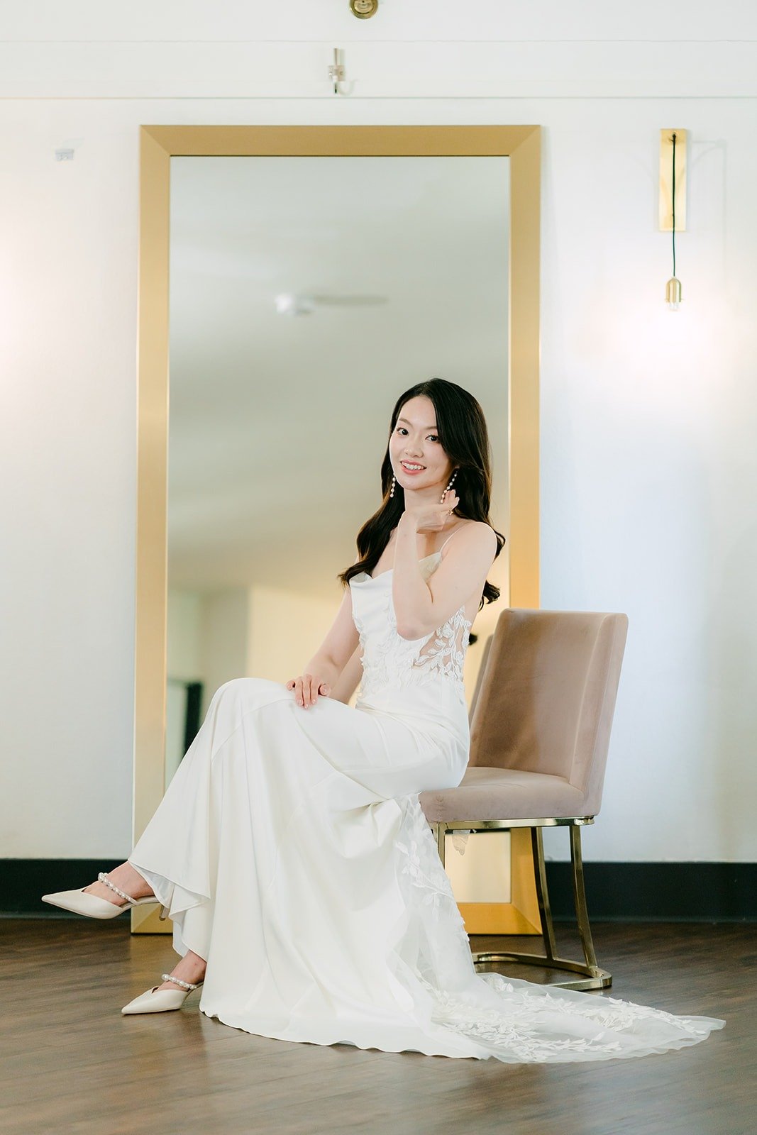 Tin in her wedding dress seated in the bridal suite