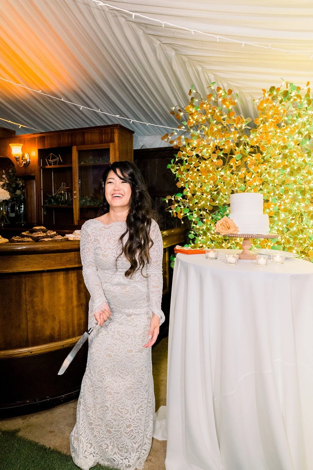 Hannah laughing beside the cake table