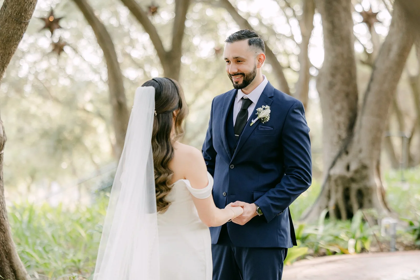 Danny smiling at Mariana in her off the shoulder gown