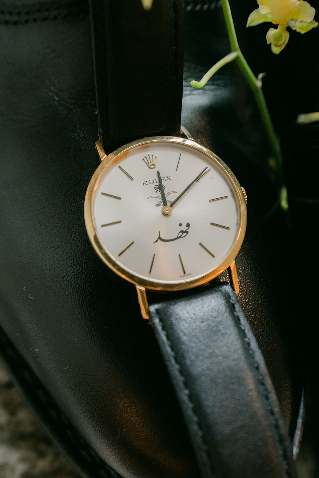 Ryan's watch resting on his black dress shoe.