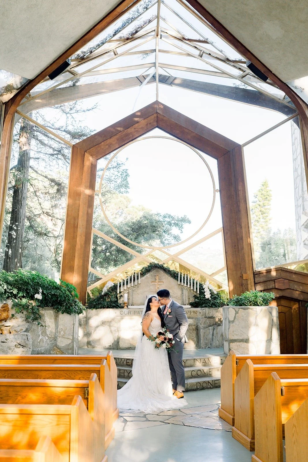 The glass and timber arches of Wayfarers Chapel frame Betsy and Mikey
