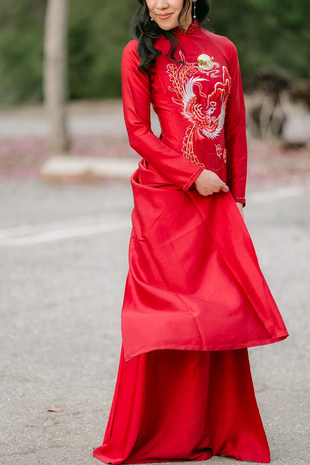 Detail of Kim's red ao dai and its long front panel.