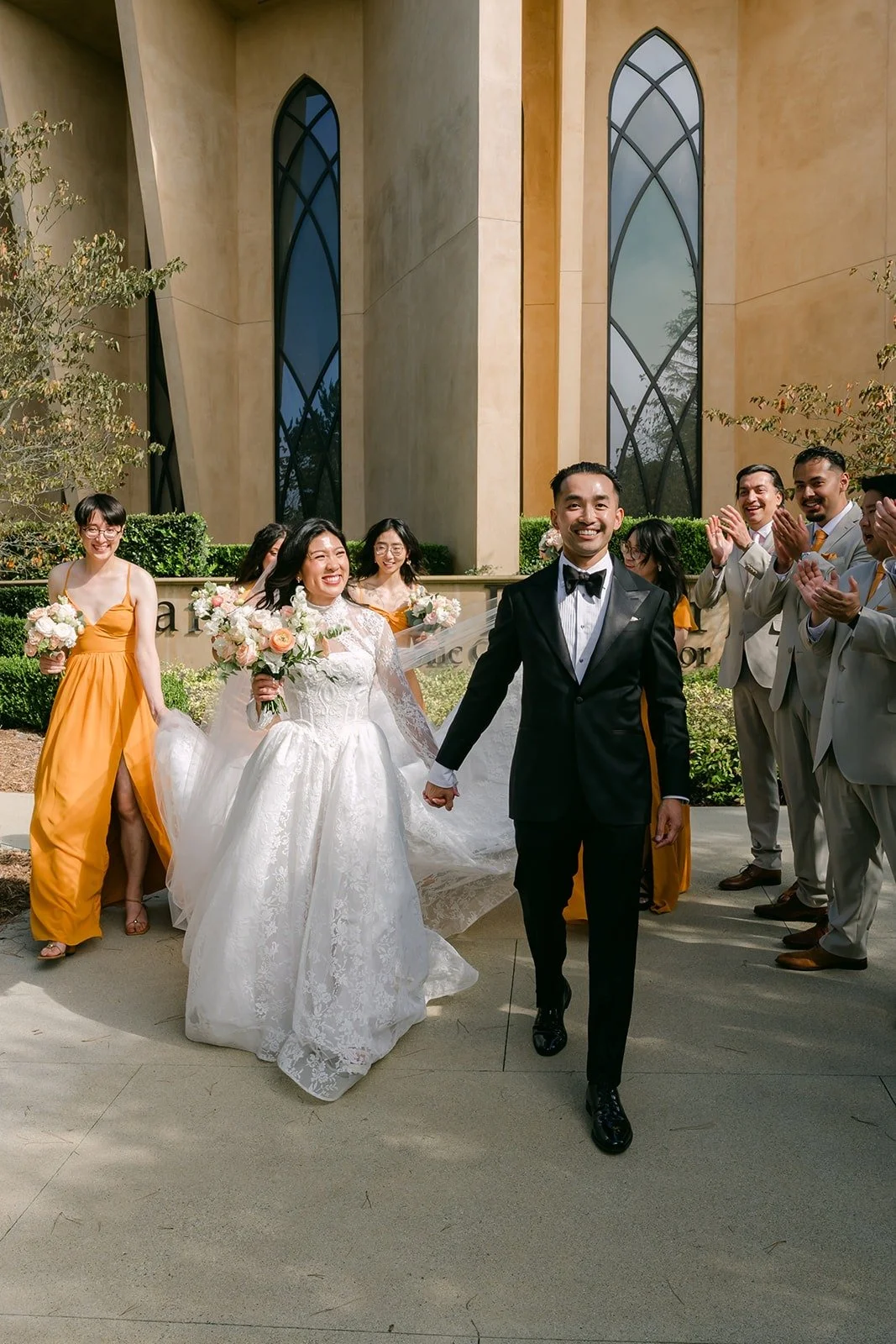 Kim and Vincent with the bridesmaids by the church windows