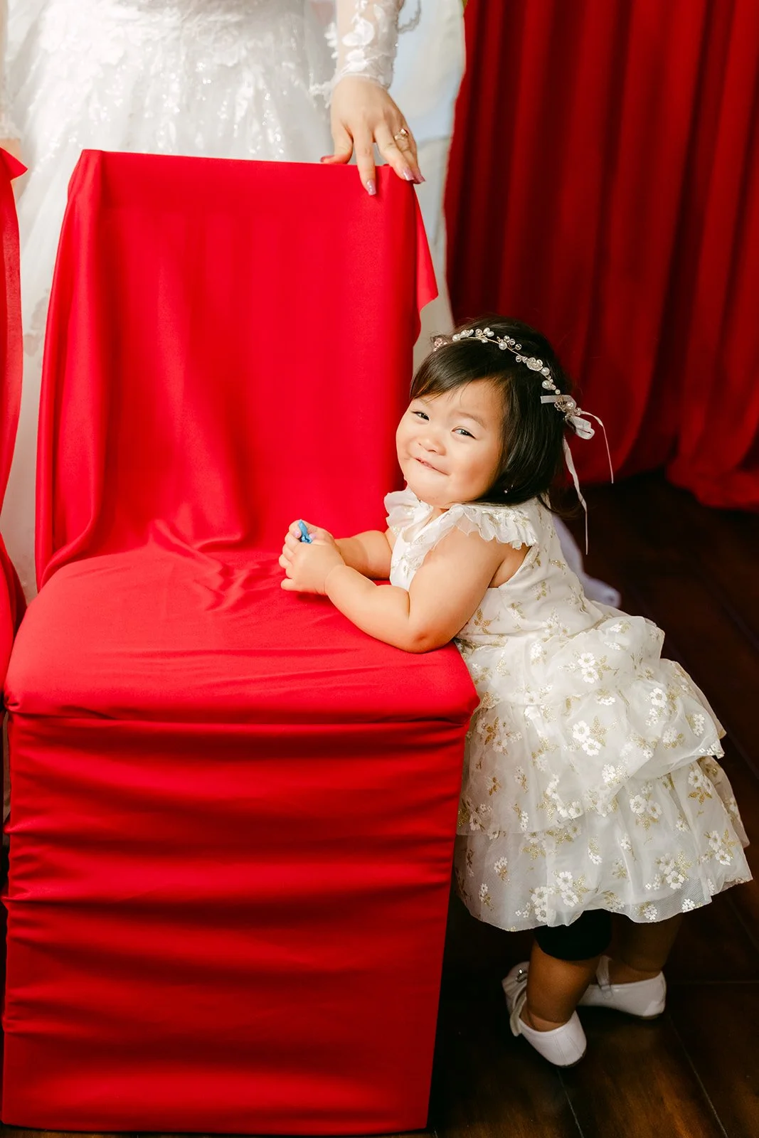 Vanessa's niece climbing onto a red chair.