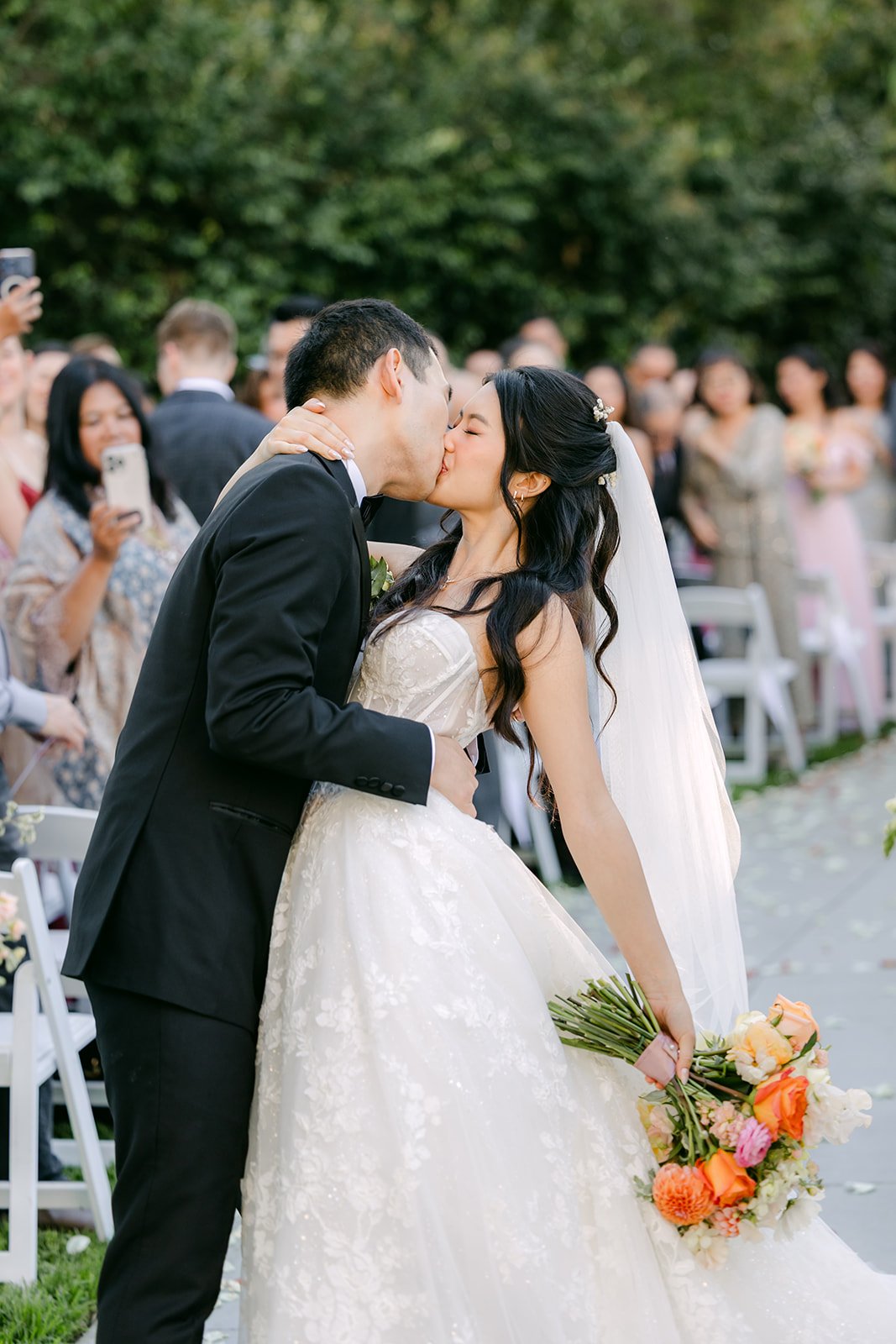 Clarissa and Austin kissing in the aisle, photographed by One and Only Production