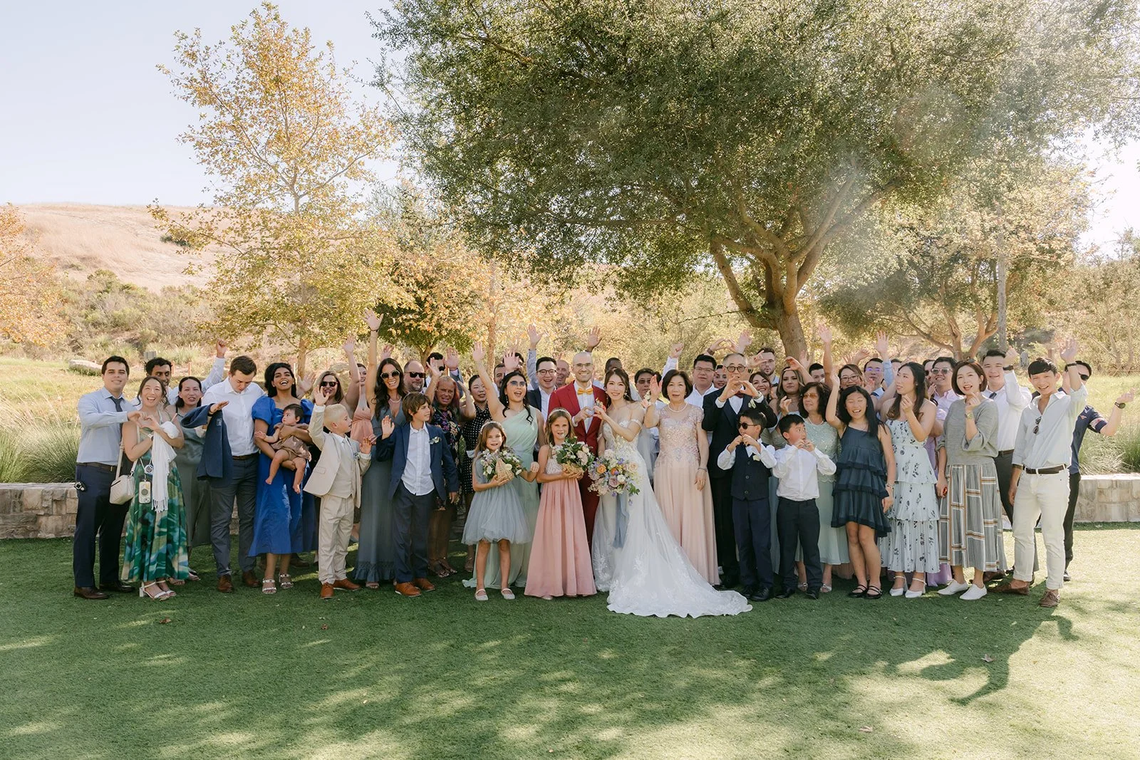 Christie and Christian with all of their guests in a big group photo on the lawn at Quail Hill.