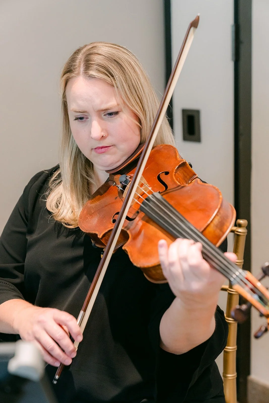 A violinist from the string trio playing during the morning celebration