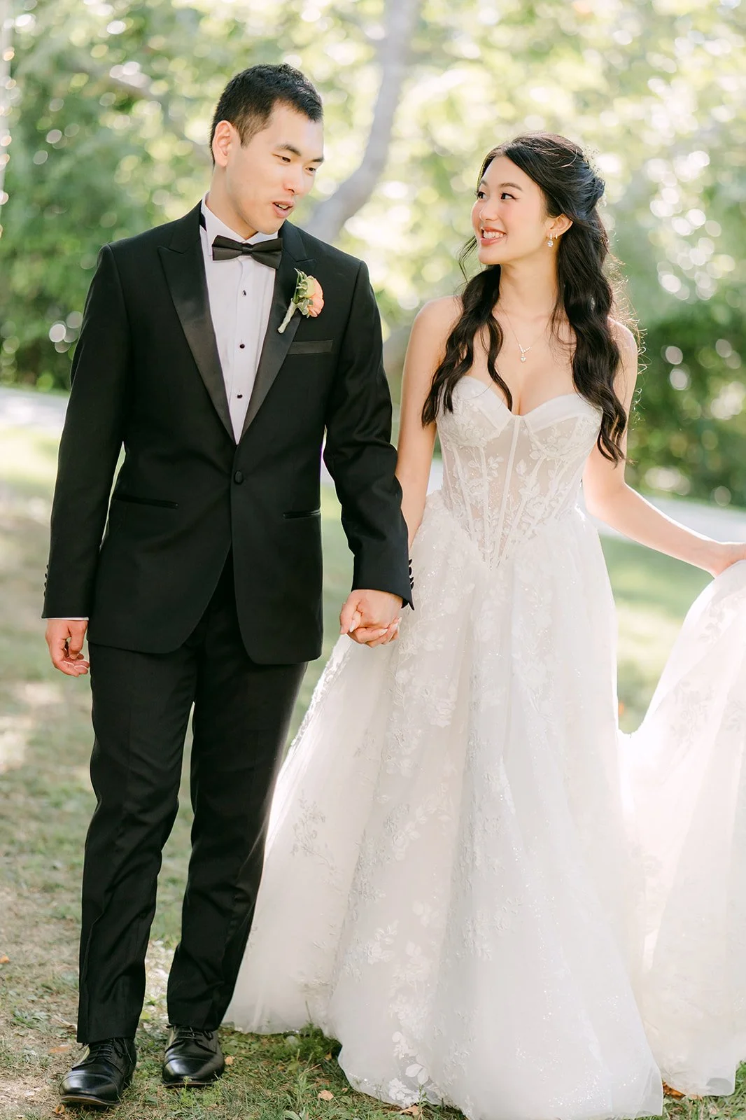 Clarissa and Austin holding hands under the trees