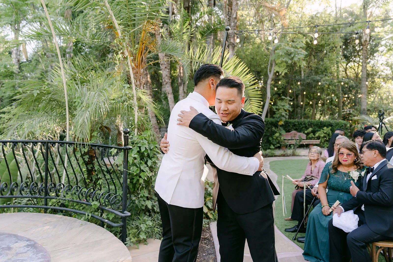 Caryl hugging a loved one at the front of the aisle before the ceremony.