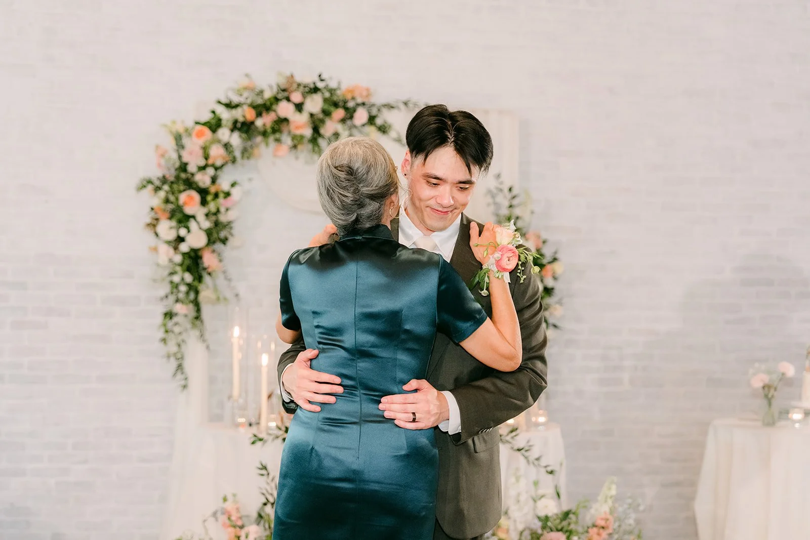 Alex smiling with his mom during their dance