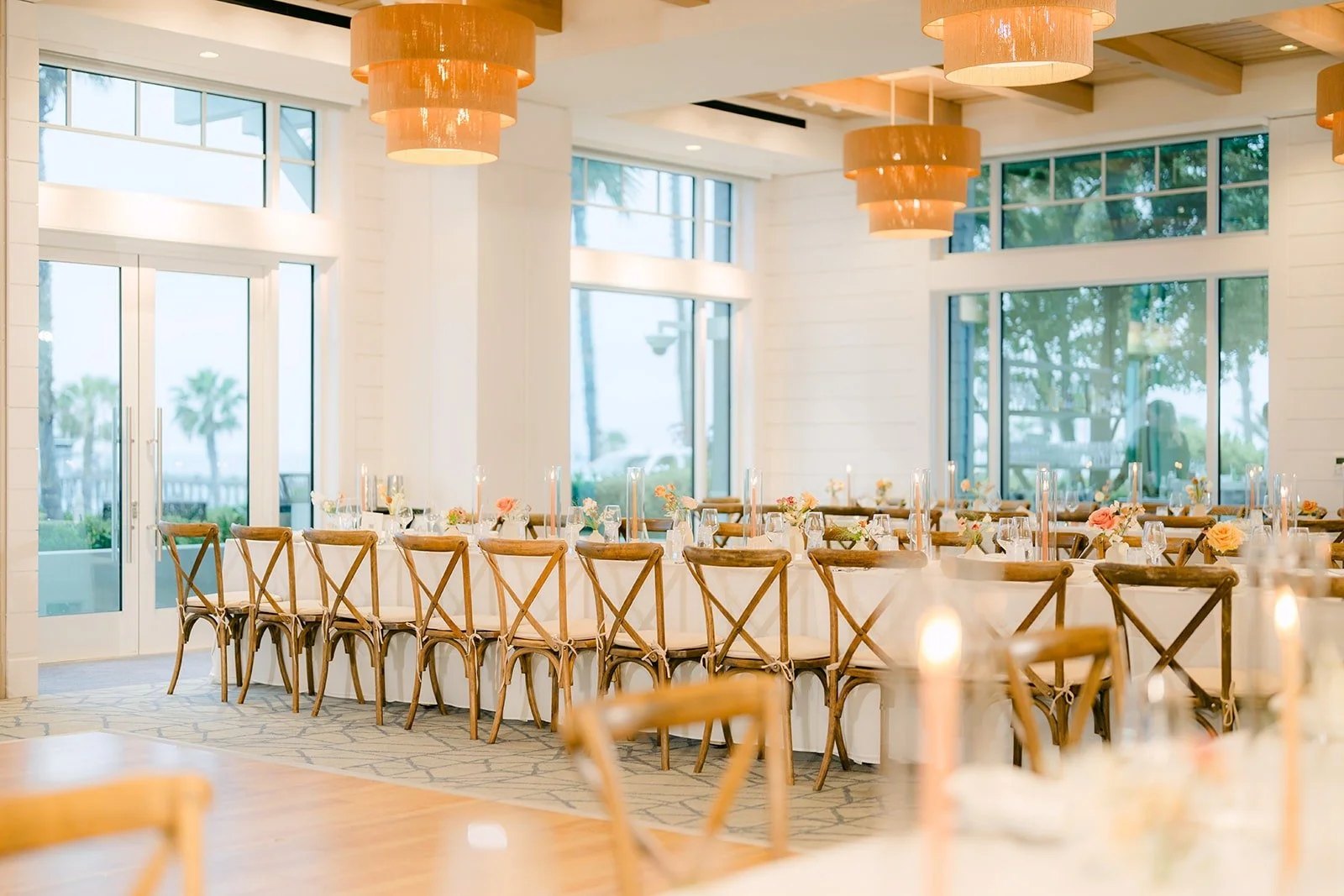 The ballroom with long tables lined up beside the ocean view windows