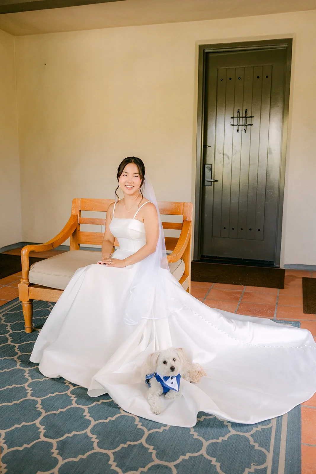 Saya seated with her gown spread and the pup at the hem