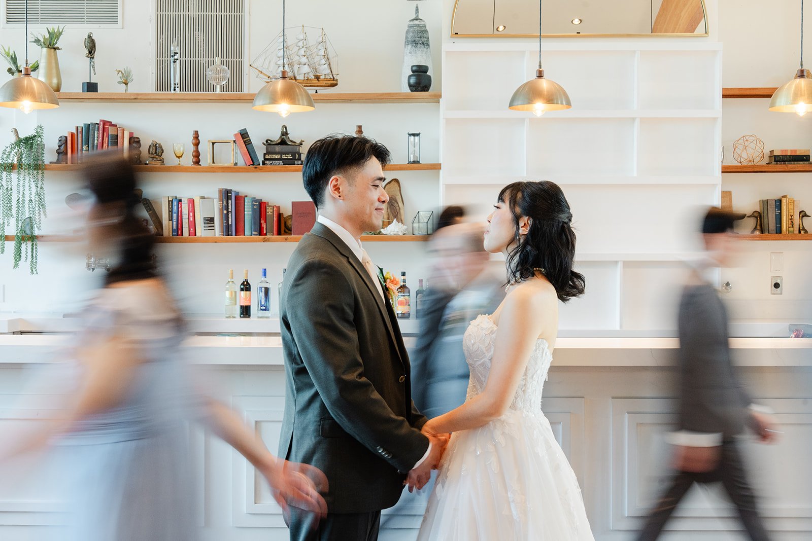 Wedding party rushing past the couple in a blur of motion