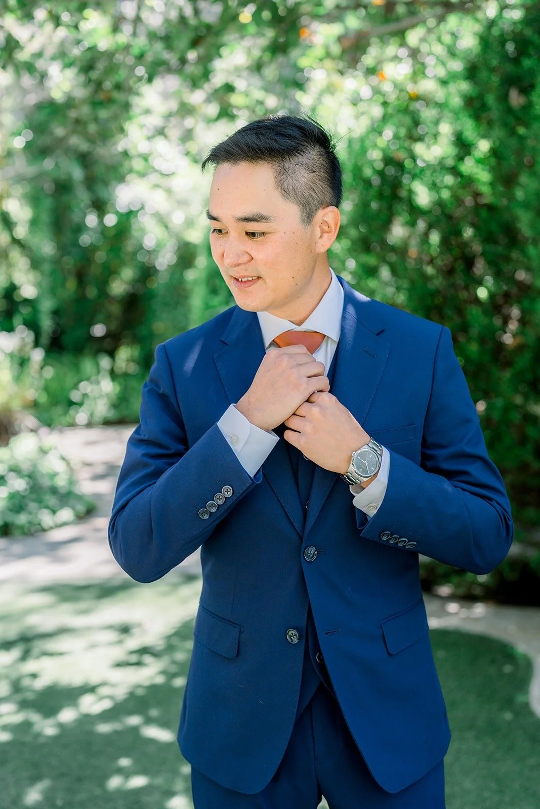 Vincent adjusting his rust tie in the garden