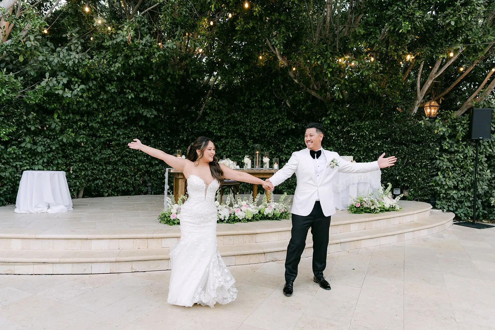 Nicole and Caryl striking a pose mid first dance on the patio at Eden Gardens.