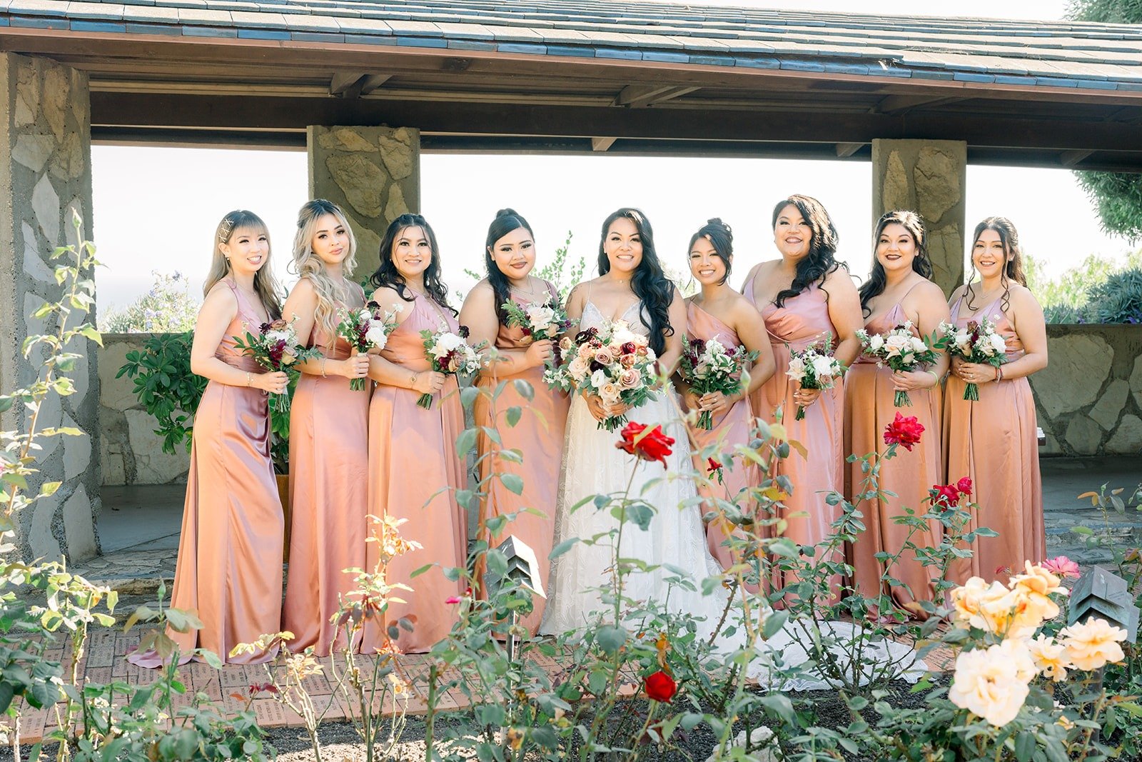 The bridesmaids in dusty rose satin with Betsy at the center