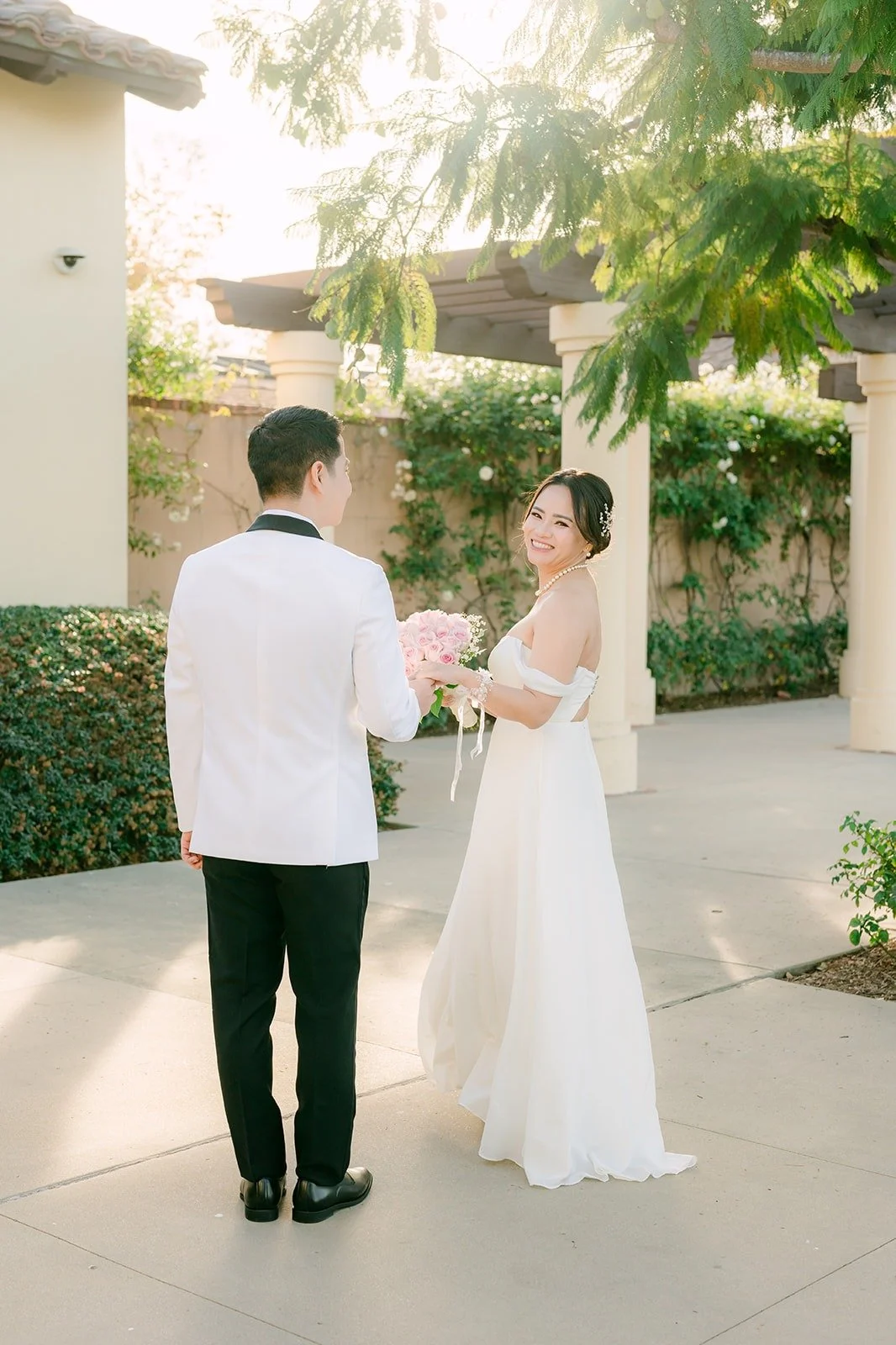 Ivy and Chungman facing each other under the pergola at Wedgewood Aliso Viejo