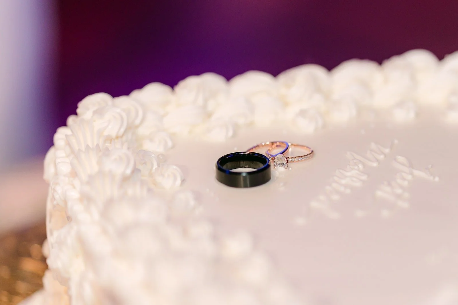 Mariana and Danny's wedding bands resting on the cake