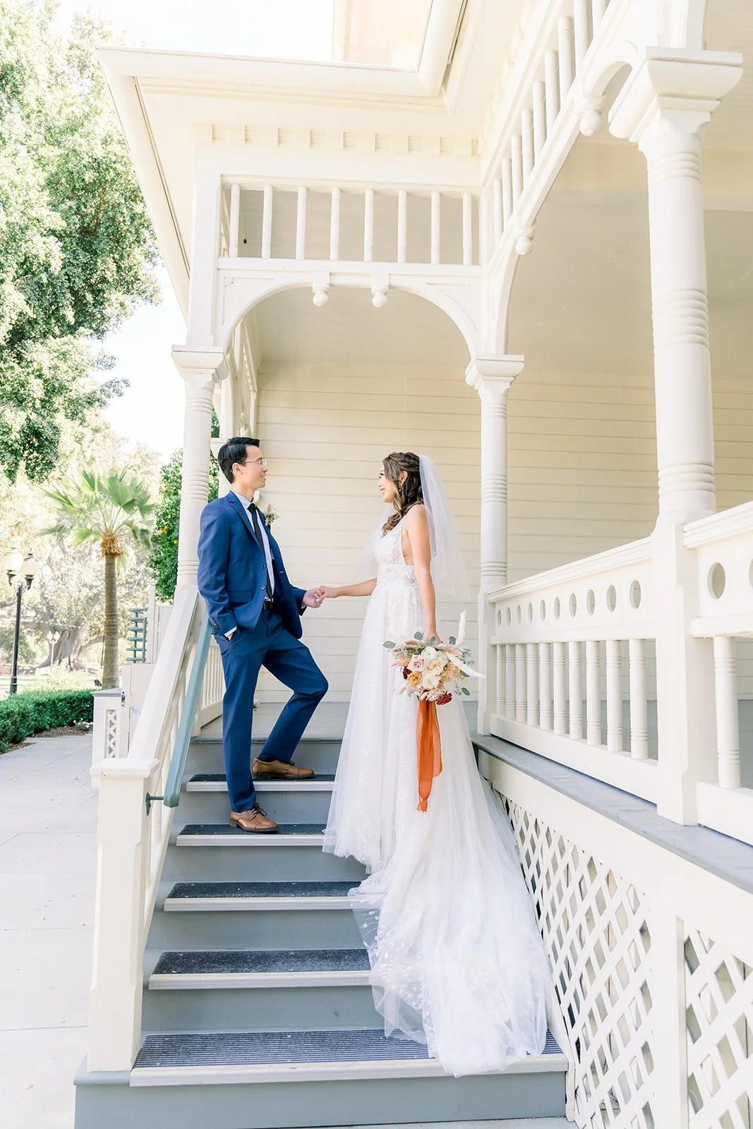 Ariel and Alex on the porch steps of the ranch house