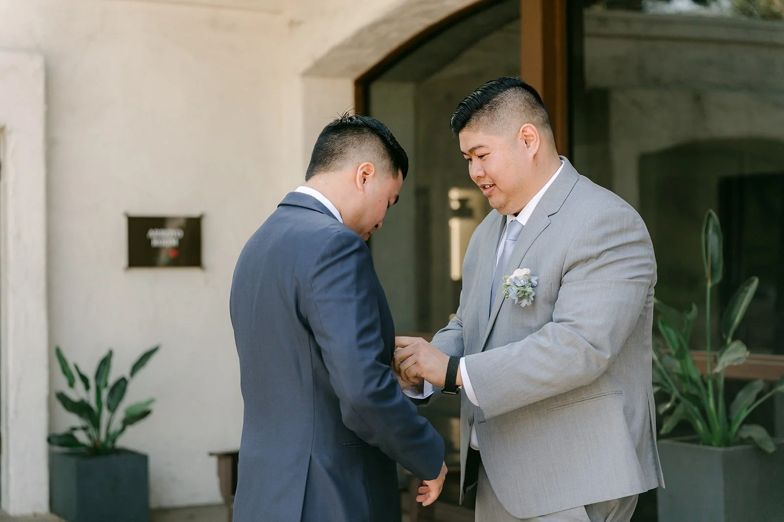 Jordan and a groomsman sharing a moment outside the clubhouse