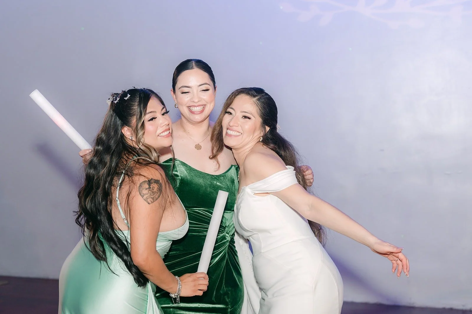 Mariana dancing with two bridesmaids holding light up sticks