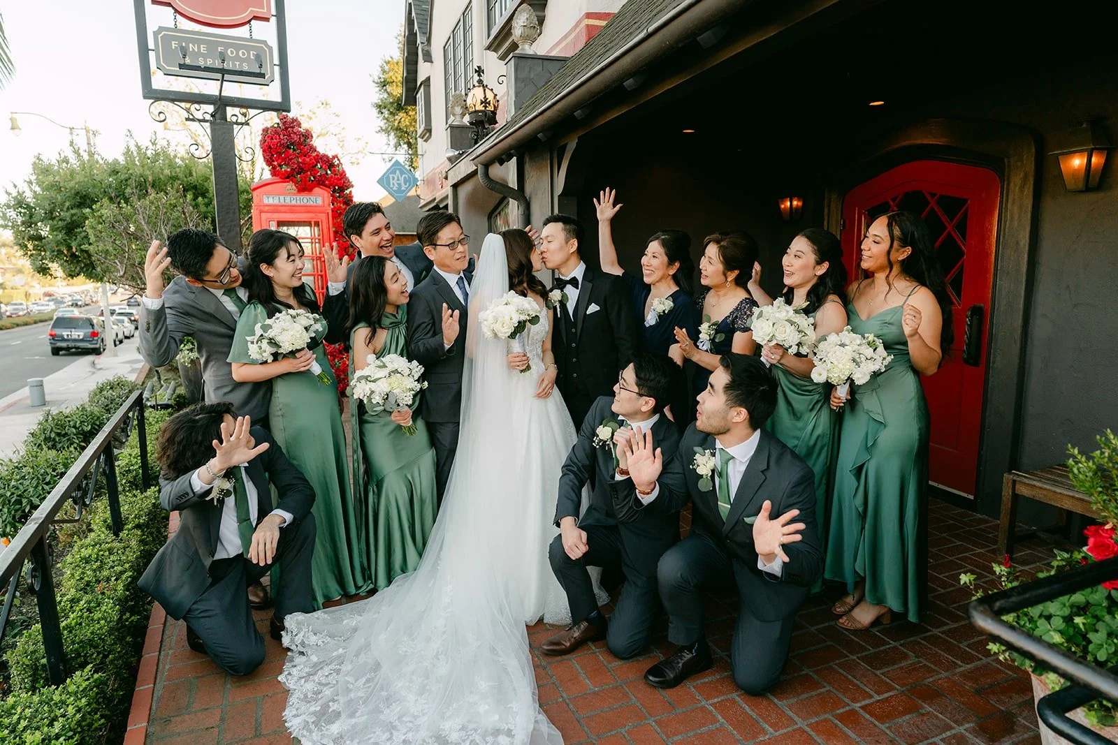 The whole wedding party cheering around Valerie and Jason outside Five Crowns