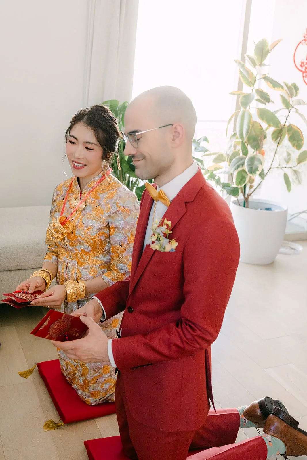 Christie and Christian kneeling side by side during the tea ceremony.