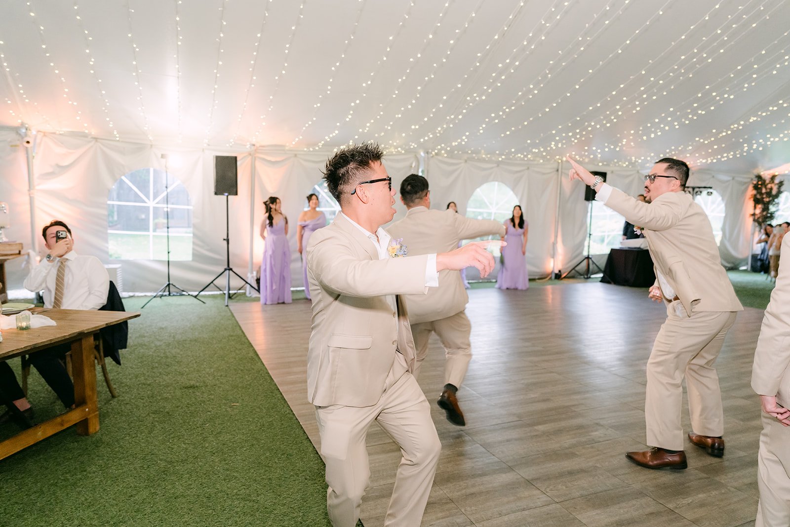 Groomsmen dancing into the Open Air Pavilion