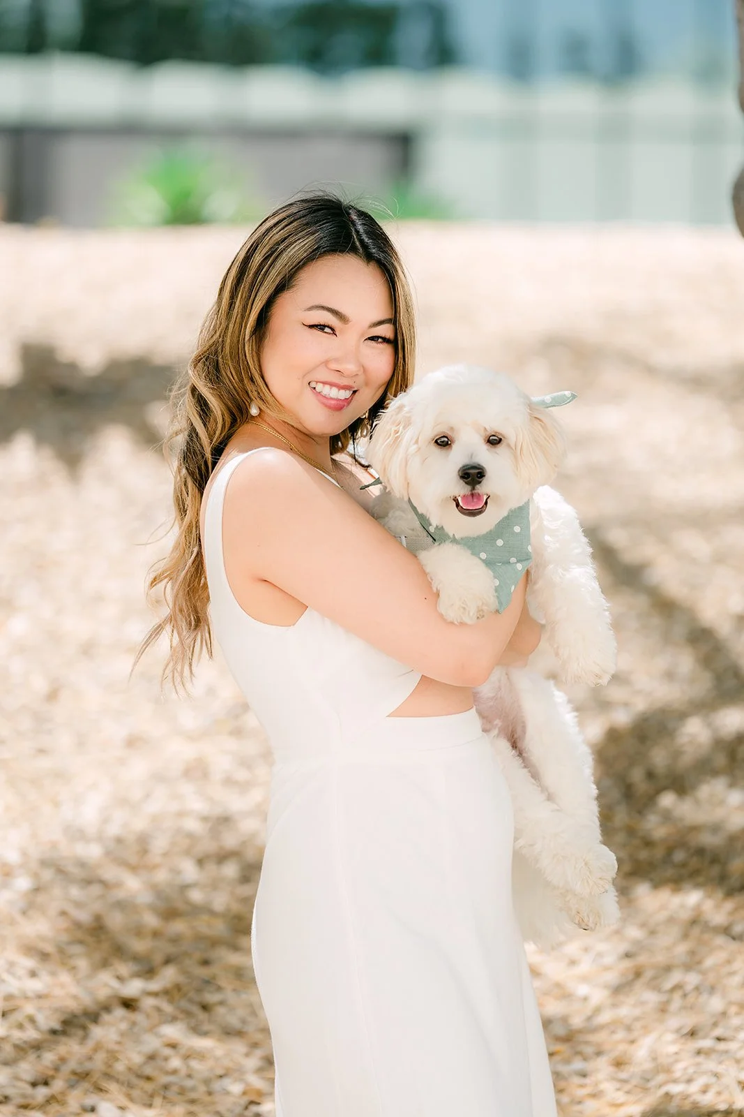 Stephanie holding Tofu in a white dress.