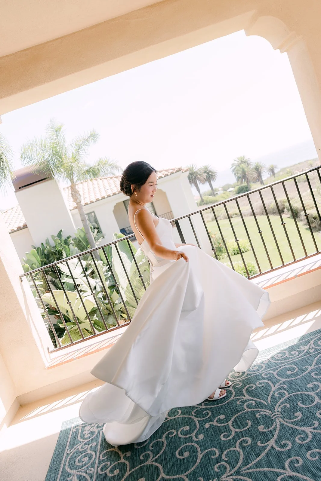 Saya twirling her gown on the balcony at Terranea