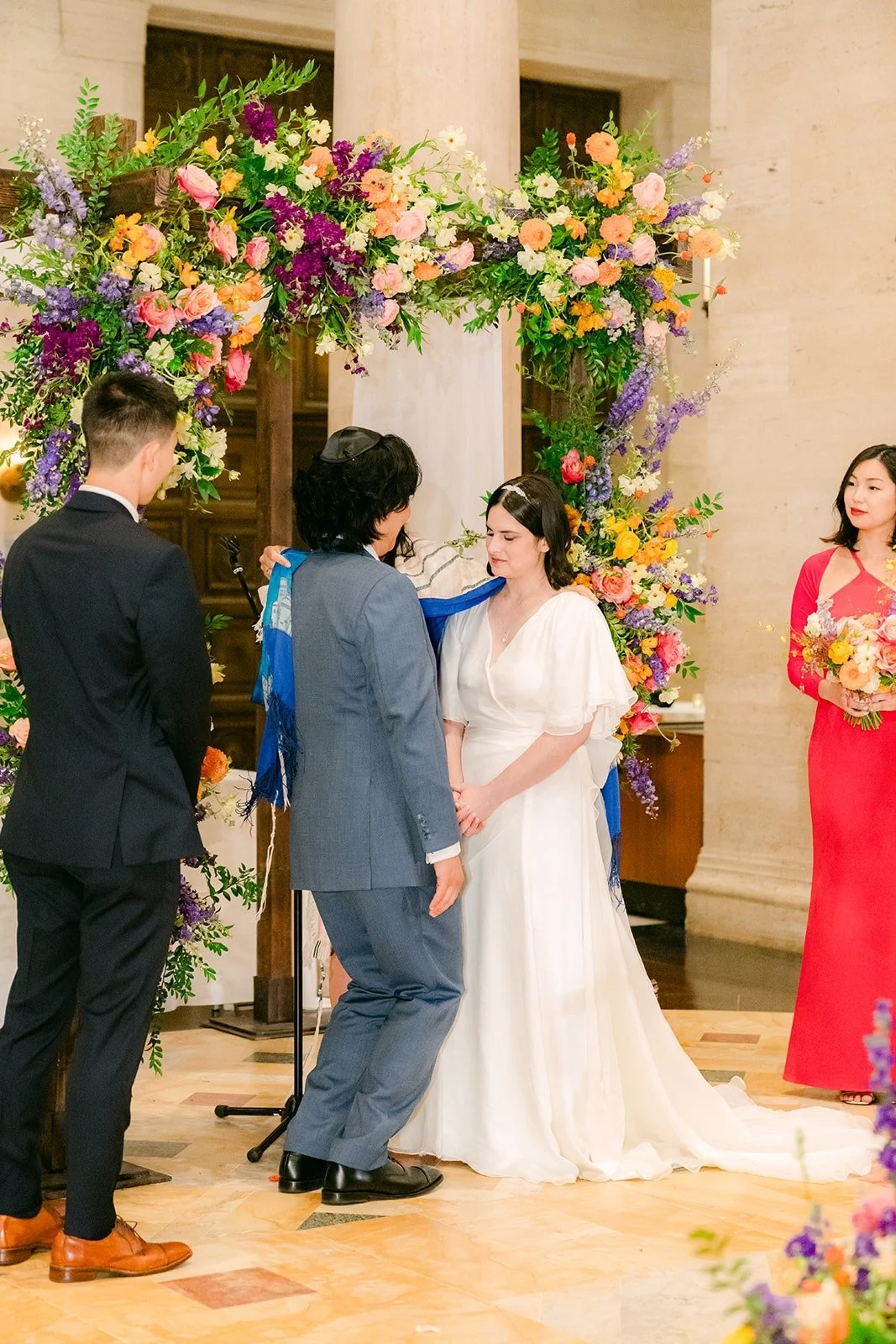 The wedding party watching as Jessie and Philip hold hands