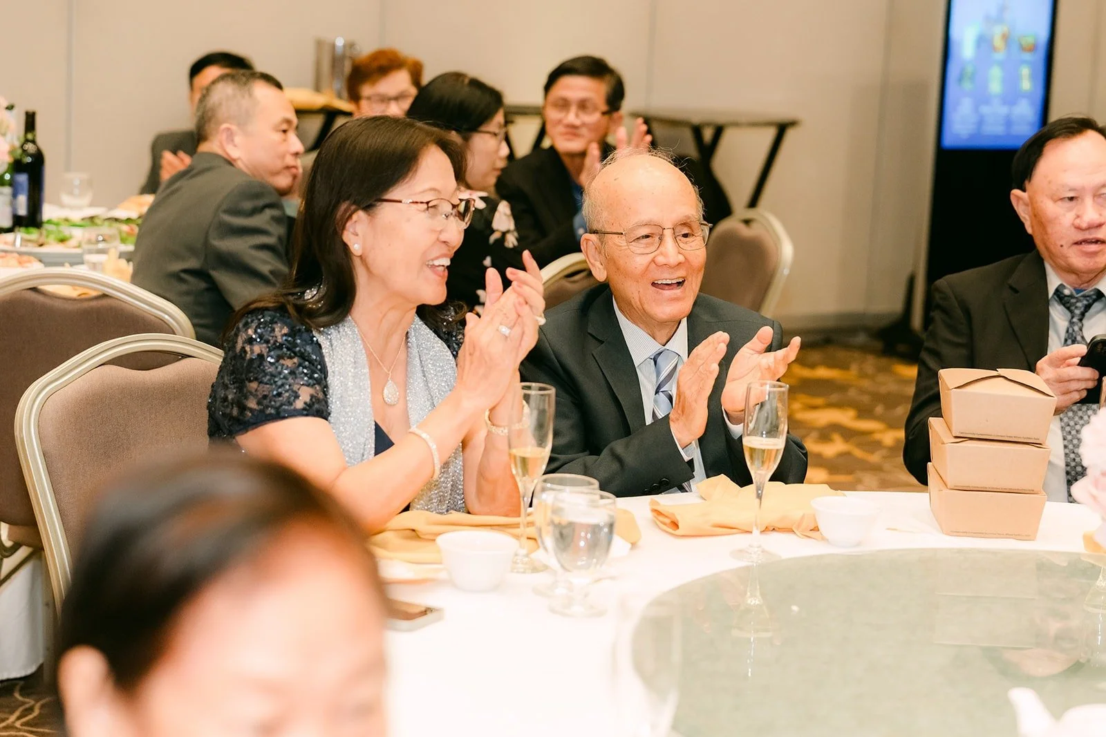 Guests smiling at their table as the speeches go on