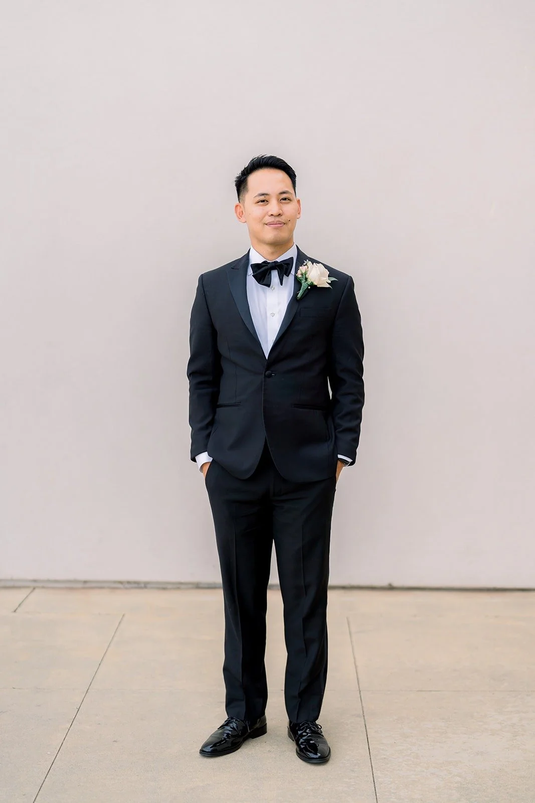 Full length portrait of Ralph in a black tuxedo with a white boutonniere