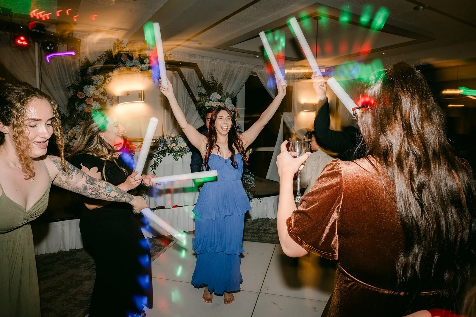 Guests with glowing foam sticks on the dance floor