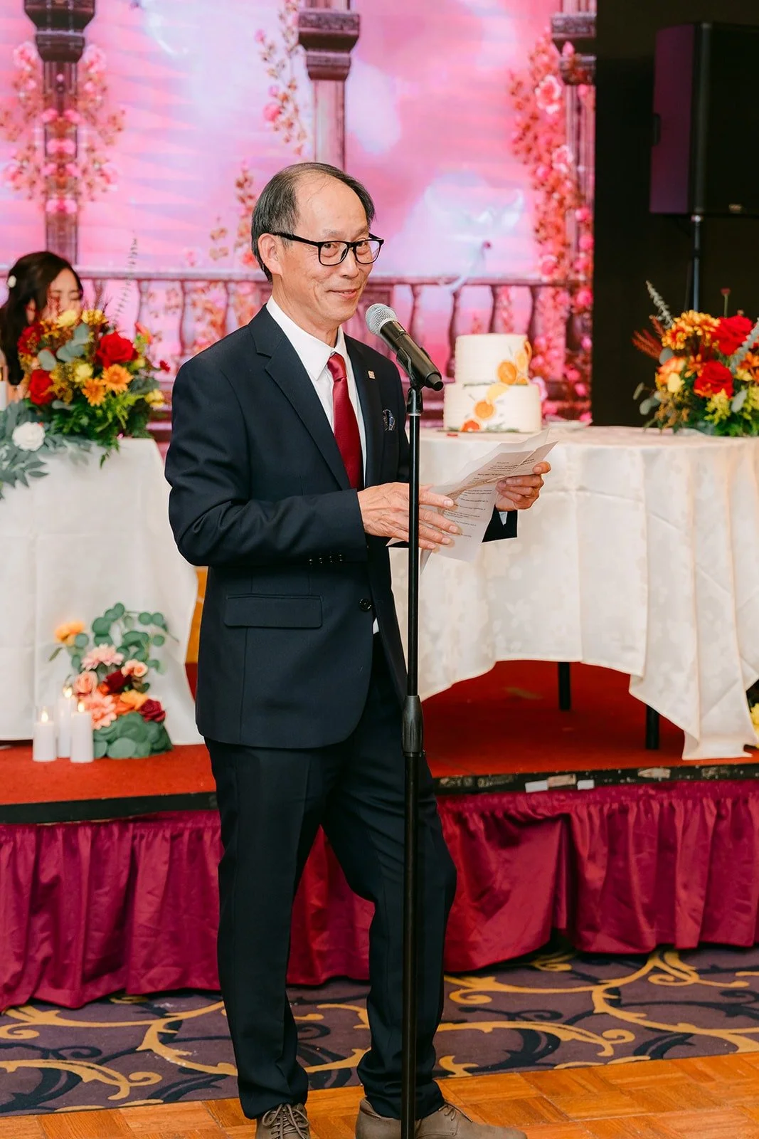 A family member speaks to the guests at the sweetheart table