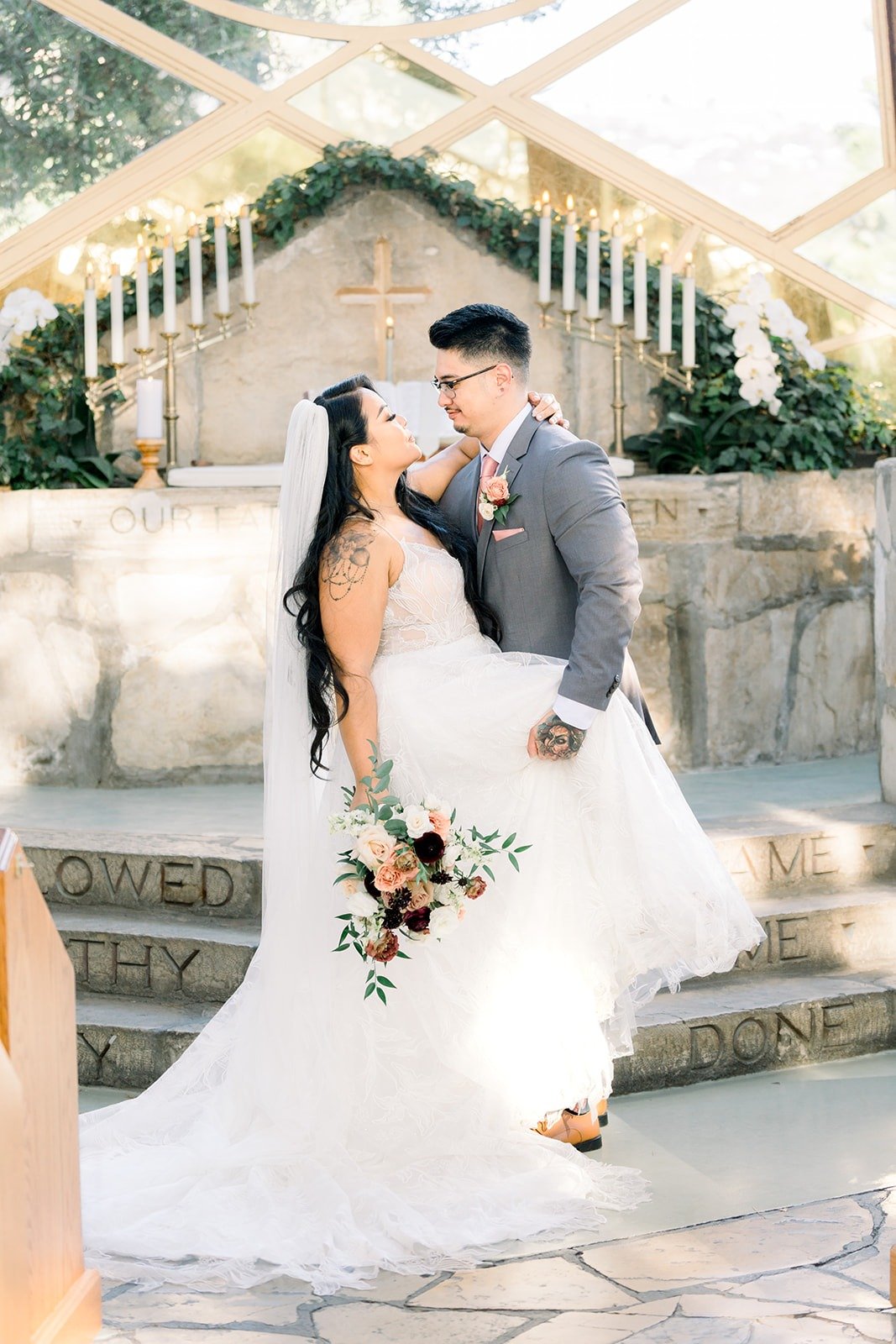 Mikey dips Betsy for a kiss by the chapel altar