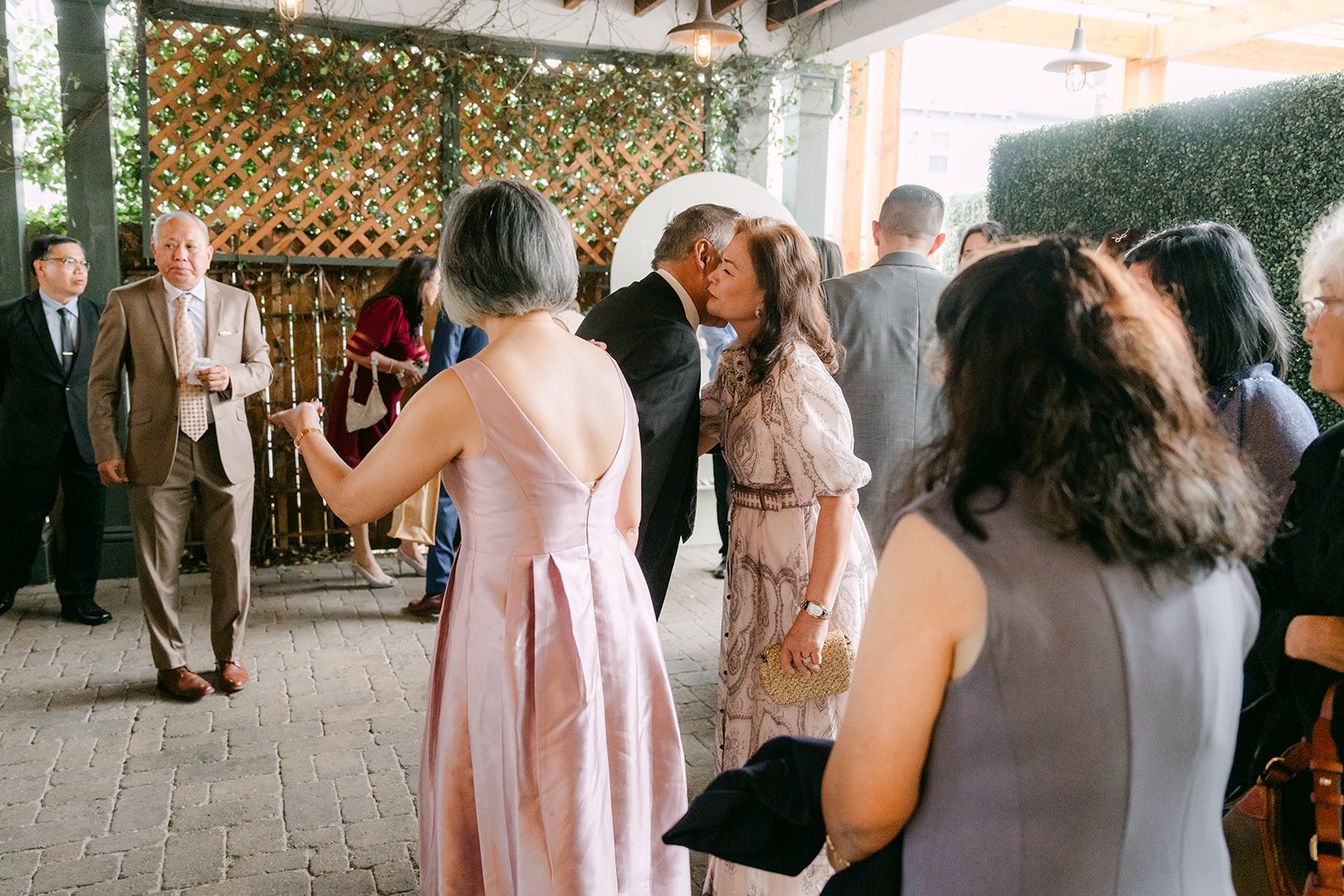Guests mingling on the patio during cocktail hour.