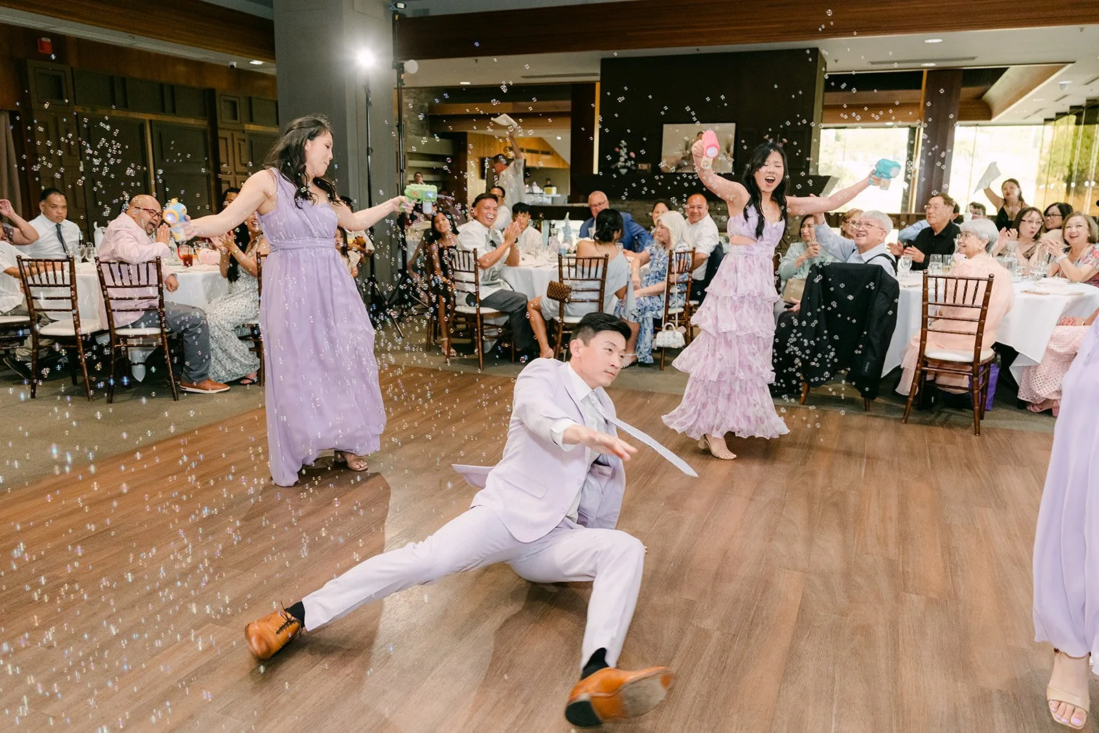 A groomsman showing off his moves at the grand entrance