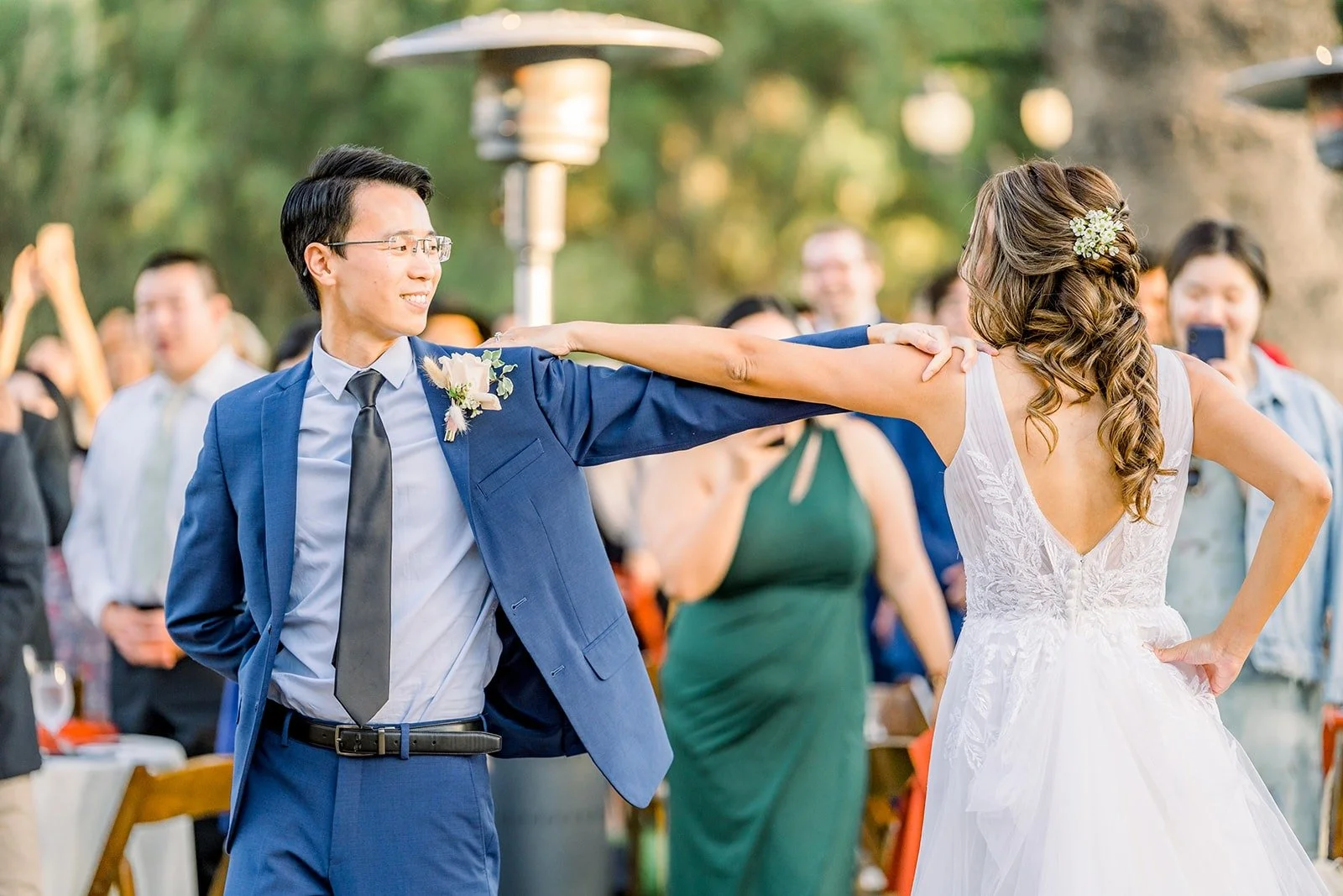 Ariel and Alex dancing as guests watch
