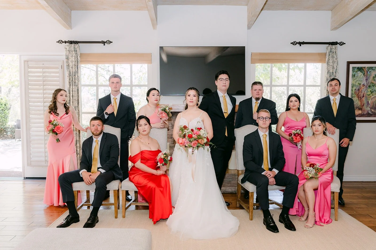 Joanne, Zach and their wedding party posed by the fireplace in the suite at Rancho Bernardo Inn