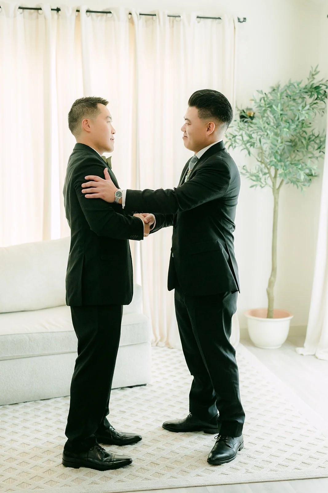 Best man Chris adjusting Vincent's lapel