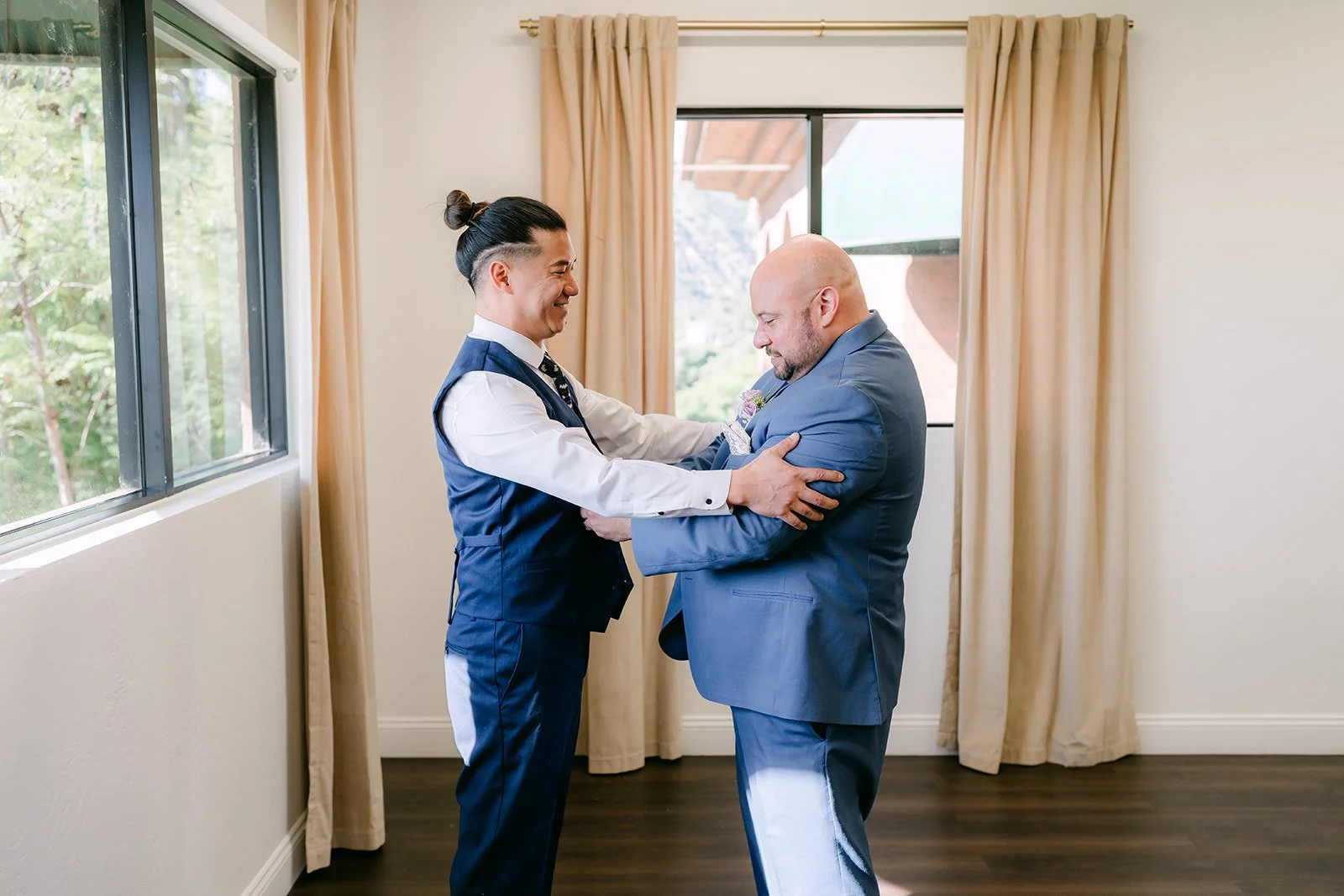 Michael getting help with his navy vest from a family member.