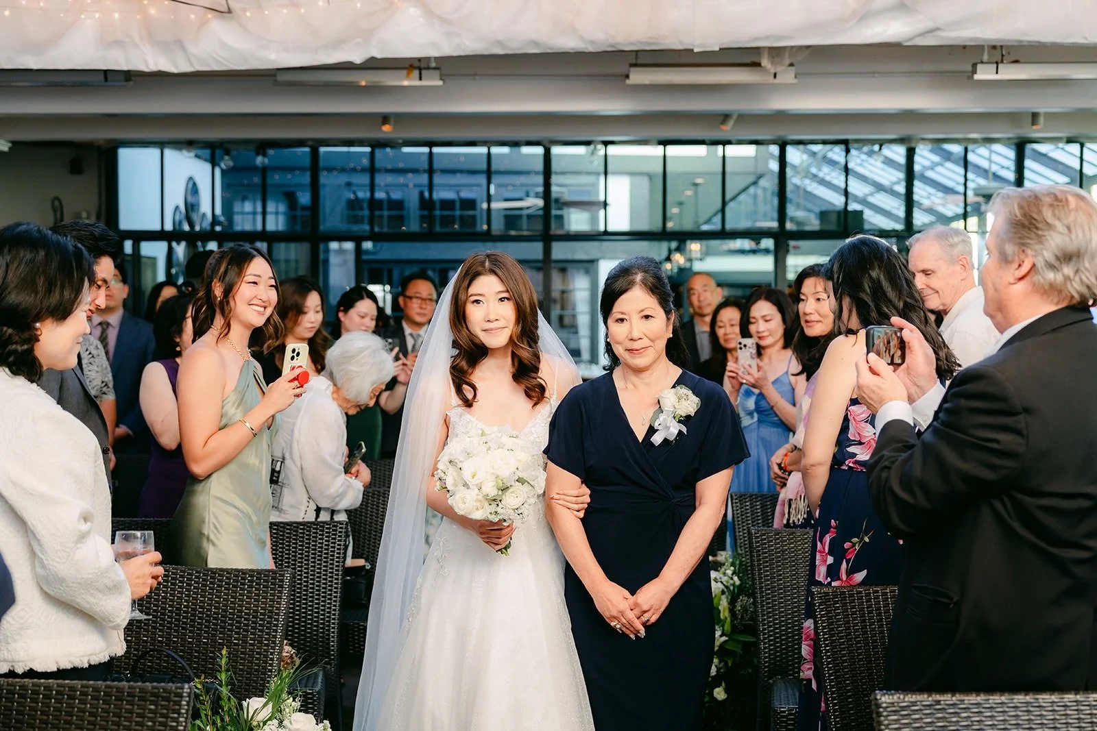 Valerie walking in with a family member in a navy dress