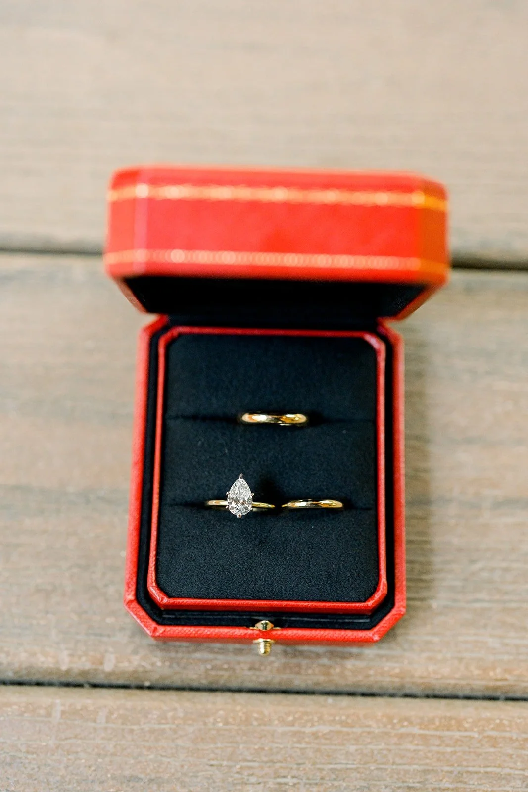 Engagement ring and wedding band in a red ring box
