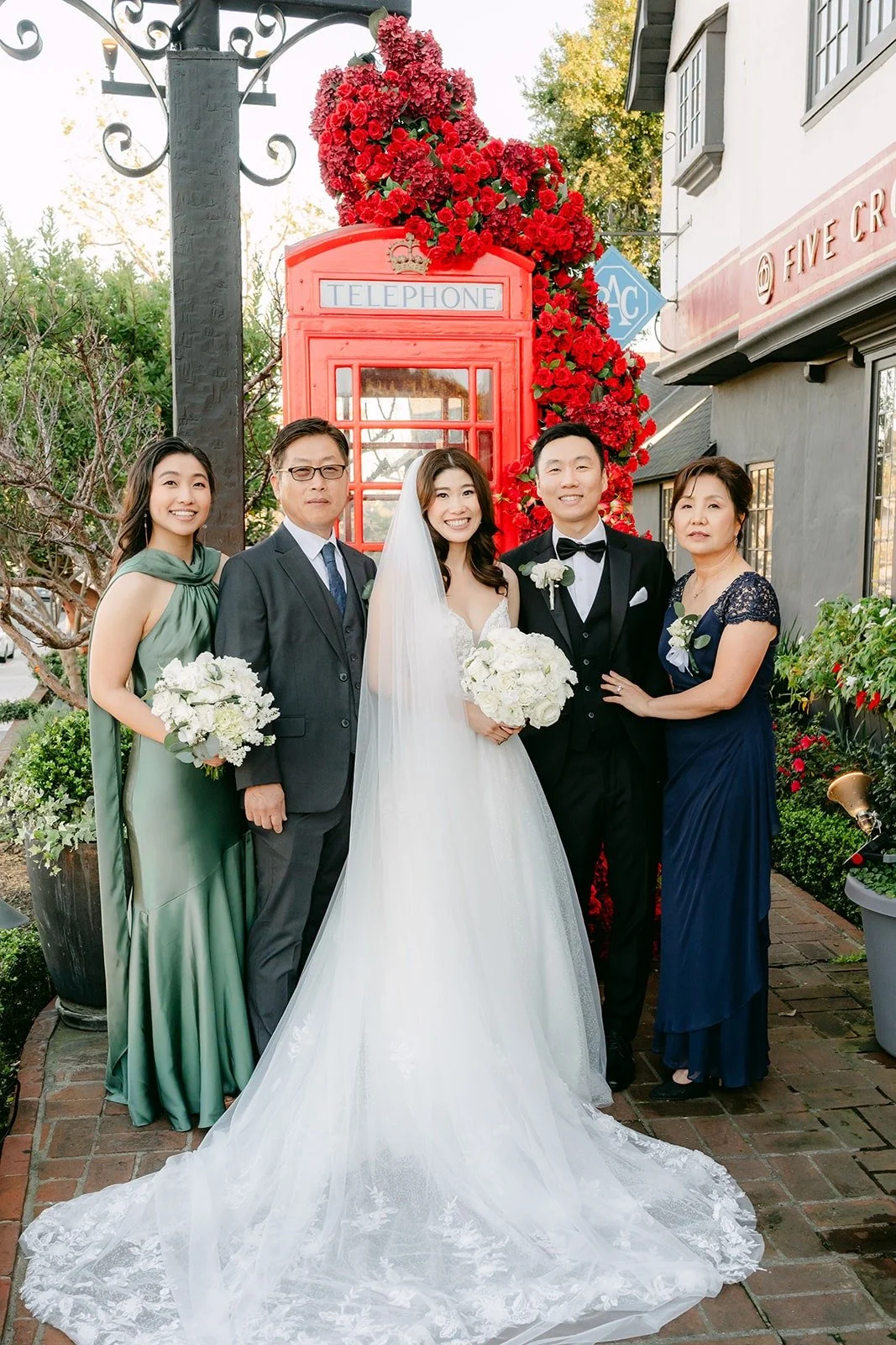 Valerie and Jason with family members in front of the red phone booth