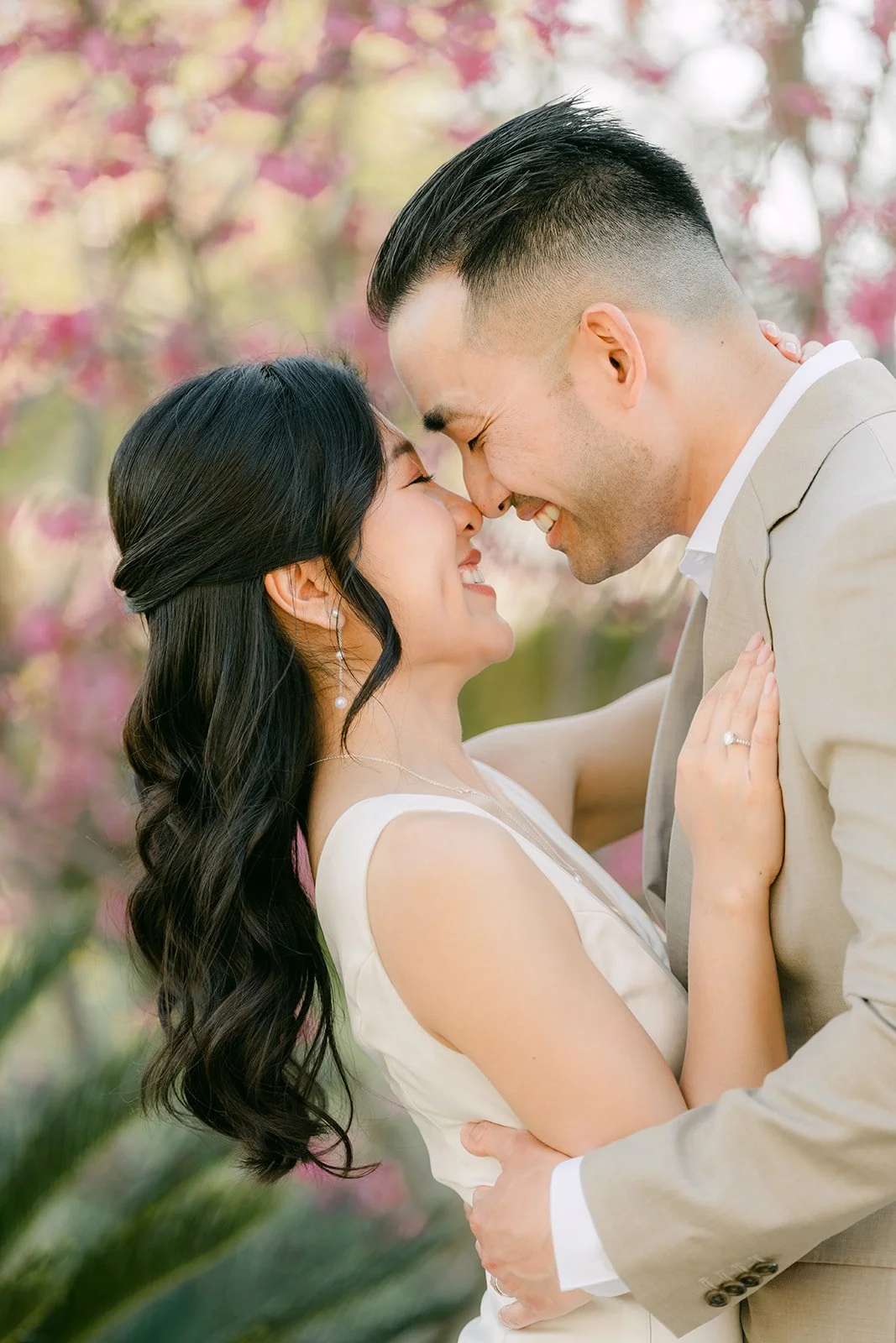 Close-up of Kim and Vincent nose to nose among the blossoms.