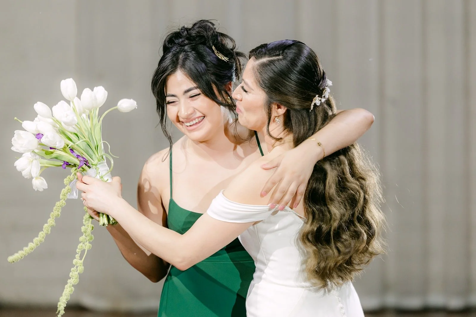 Mariana hugging a bridesmaid after a toast